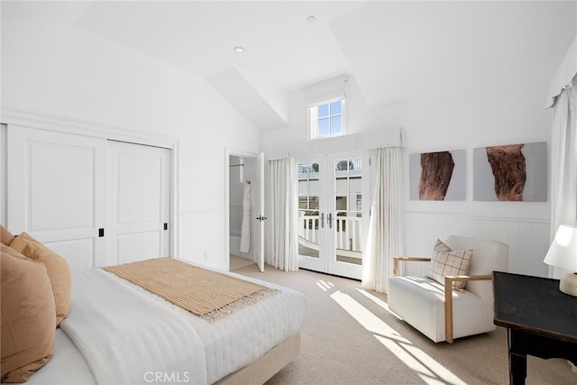 carpeted bedroom with lofted ceiling, french doors, access to outside, and a closet