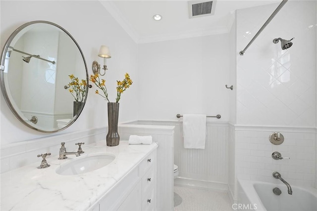 full bathroom featuring toilet, vanity, tile patterned flooring, tiled shower / bath combo, and crown molding