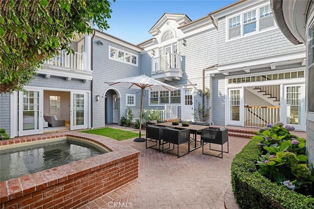 back of property with a patio area and a balcony