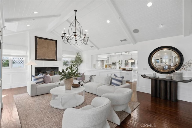 living room featuring a healthy amount of sunlight, beam ceiling, hardwood / wood-style flooring, and high vaulted ceiling