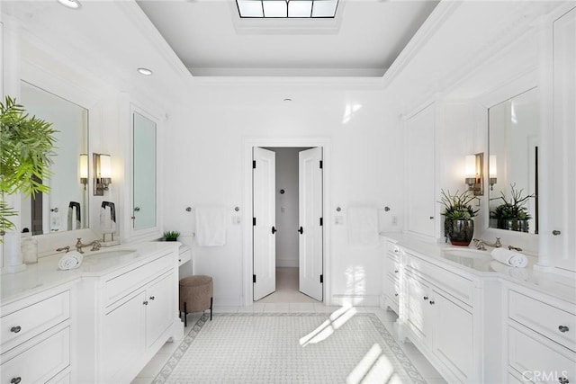 bathroom with vanity, tile patterned floors, and a tray ceiling