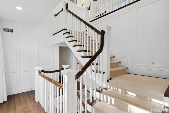 stairs featuring hardwood / wood-style flooring