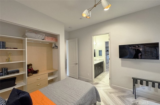 bedroom featuring a closet, light parquet flooring, and ensuite bath