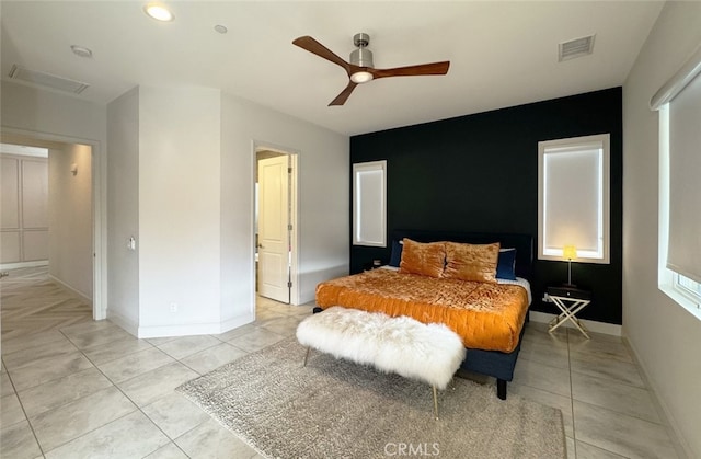 tiled bedroom with ceiling fan