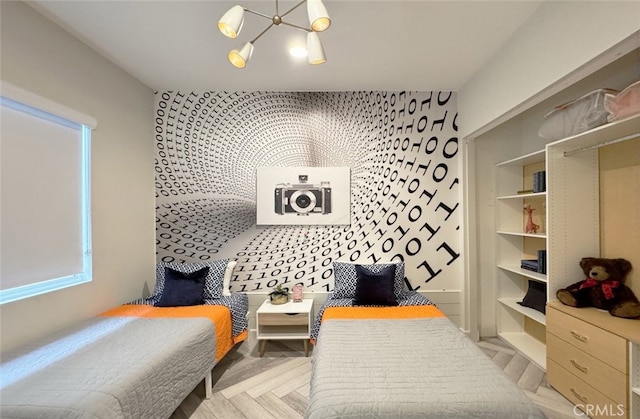 bedroom with a chandelier and light parquet flooring