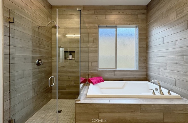 bathroom featuring separate shower and tub