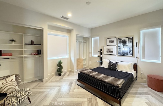 bedroom featuring a closet and light parquet flooring