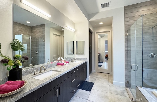 bathroom featuring walk in shower, vanity, and tile patterned floors