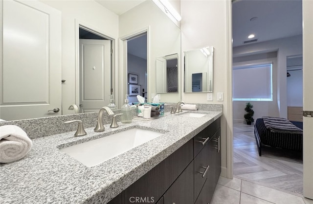 bathroom with parquet flooring and vanity