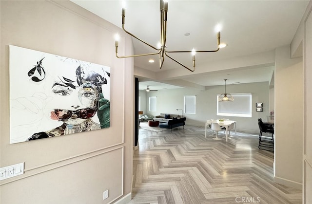 interior space featuring light parquet flooring and ceiling fan with notable chandelier