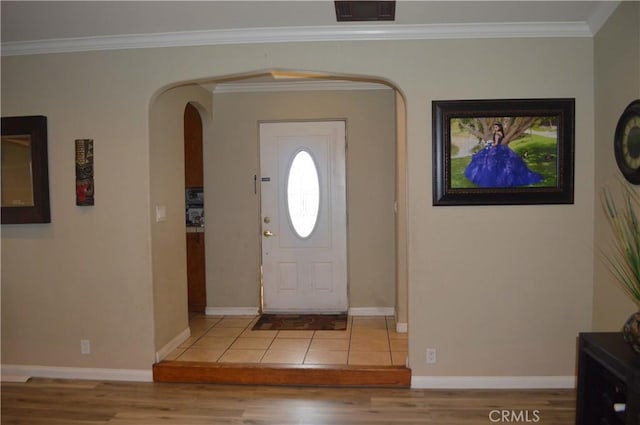 foyer with light wood-type flooring and ornamental molding