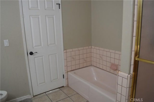 bathroom featuring toilet, a bathtub, and tile patterned floors