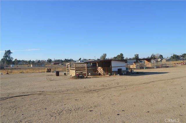 view of yard featuring an outbuilding and a rural view