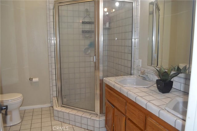 bathroom with tile patterned floors, toilet, an enclosed shower, and vanity