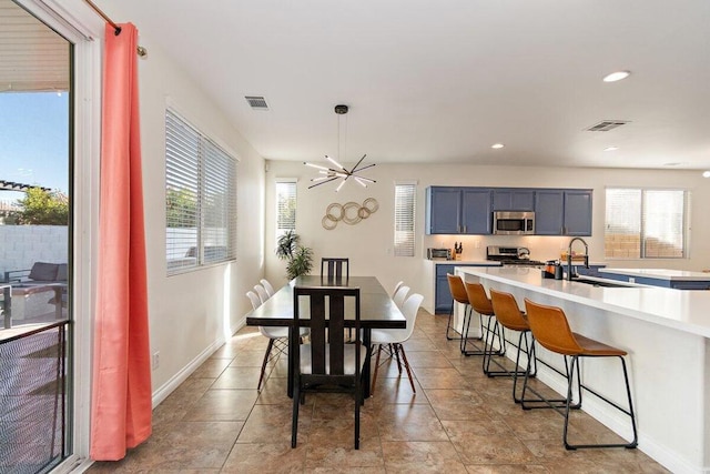 dining room featuring sink and a notable chandelier