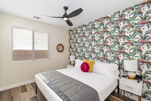 bedroom with ceiling fan and wood-type flooring