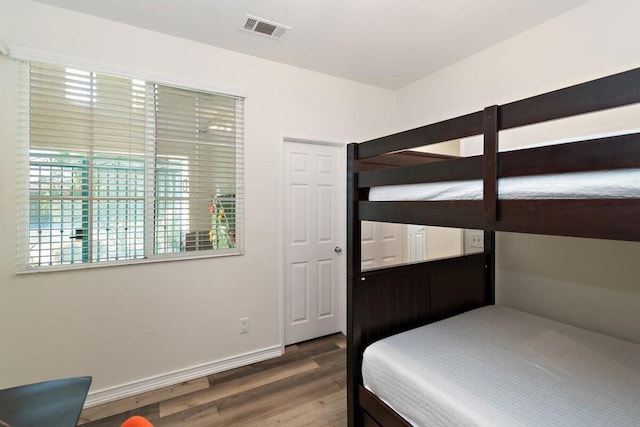 bedroom with dark hardwood / wood-style floors