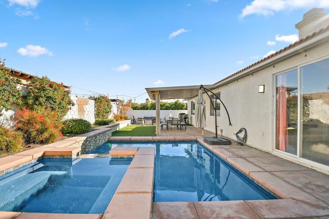 view of pool with an in ground hot tub