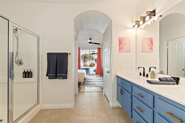 bathroom with ceiling fan, tile patterned floors, an enclosed shower, and vanity