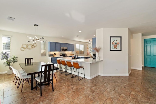 dining area featuring a notable chandelier and sink