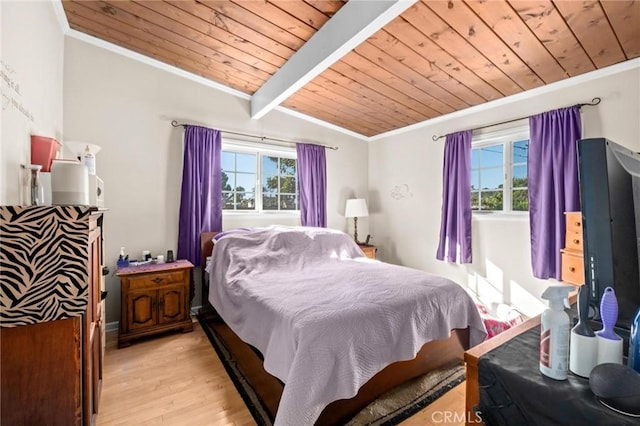 bedroom featuring multiple windows, lofted ceiling with beams, wood ceiling, and light wood-type flooring