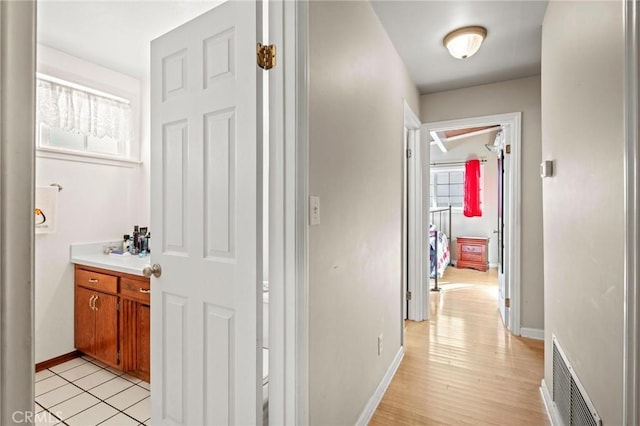 corridor featuring light tile patterned floors