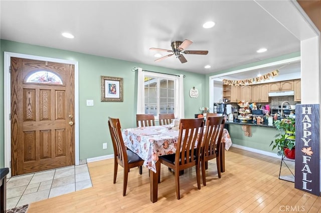 dining space featuring light hardwood / wood-style floors, ceiling fan, and sink