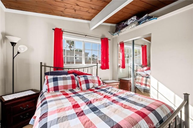 bedroom featuring multiple windows, crown molding, a closet, and wood ceiling