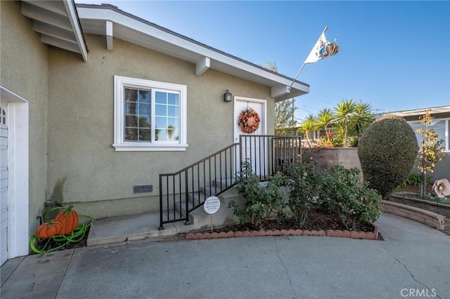 entrance to property with a patio area