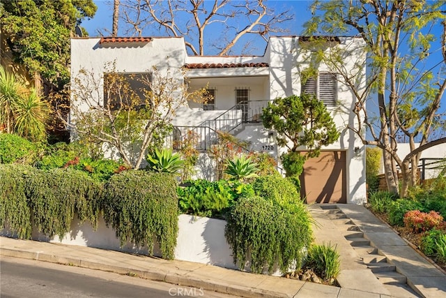 mediterranean / spanish home with a garage