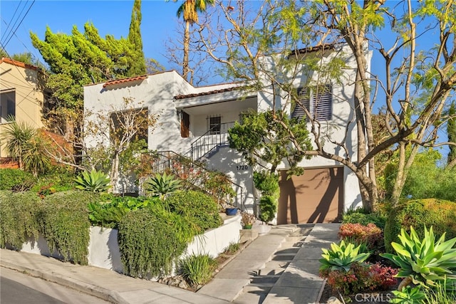 mediterranean / spanish home with a balcony and a garage