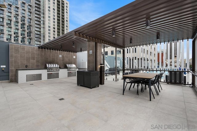 view of patio featuring a grill and an outdoor kitchen