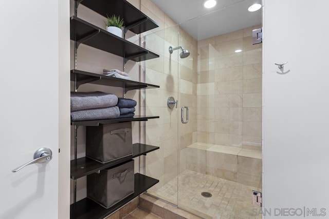 bathroom featuring a shower with shower door