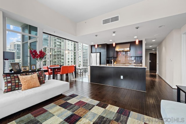 interior space with dark wood-type flooring and floor to ceiling windows