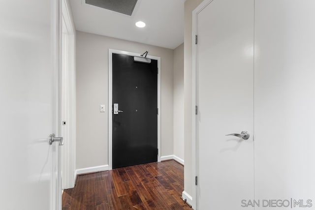 hall with dark hardwood / wood-style flooring