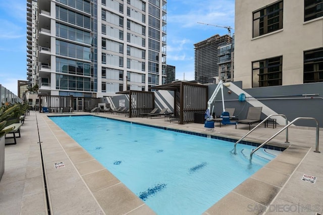 view of swimming pool featuring a patio area