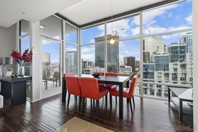 dining area featuring floor to ceiling windows and hardwood / wood-style flooring