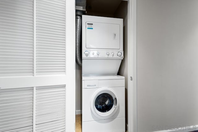 laundry area featuring stacked washer / drying machine