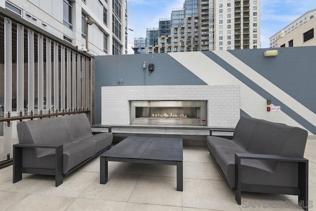 view of patio / terrace with an outdoor living space with a fireplace