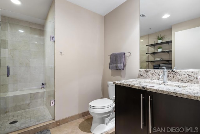 bathroom with vanity, toilet, tile patterned floors, and walk in shower