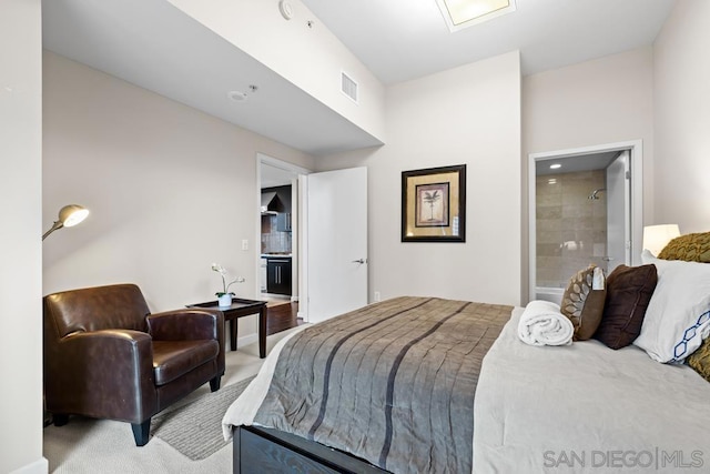 carpeted bedroom with ensuite bath