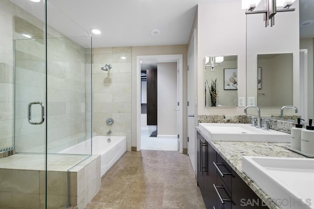 bathroom with independent shower and bath, an inviting chandelier, and vanity