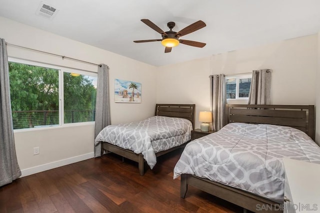 bedroom with dark hardwood / wood-style floors and ceiling fan