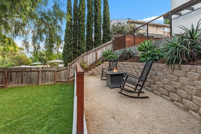 view of yard with a fire pit