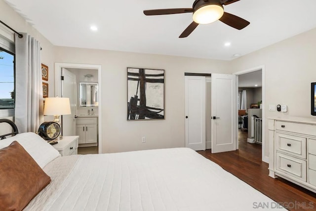 bedroom with dark hardwood / wood-style flooring, ensuite bath, and ceiling fan