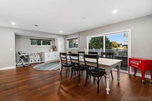 dining space with dark hardwood / wood-style flooring