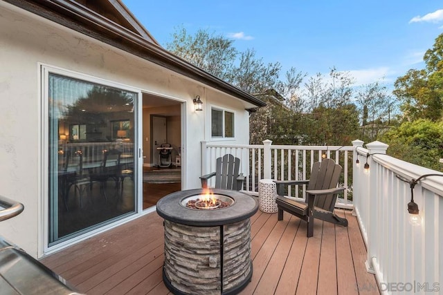 wooden deck with a fire pit