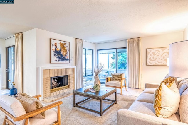 living room with a brick fireplace and a textured ceiling