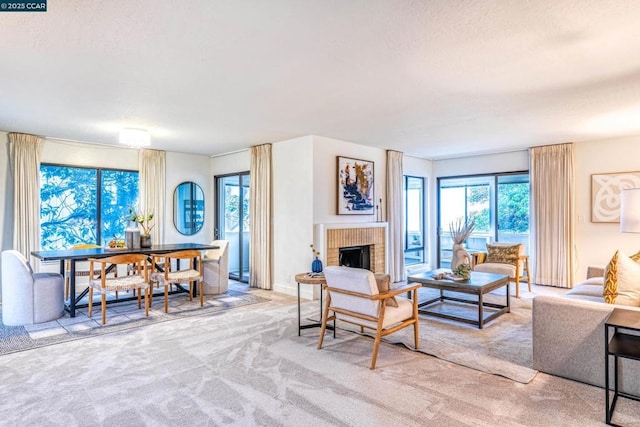 living room with a brick fireplace and light colored carpet