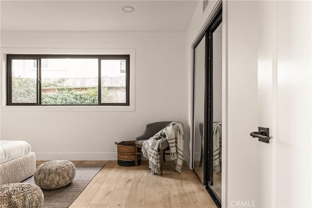 living area with light hardwood / wood-style flooring